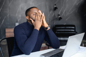 Image of a man with traumatic memories sitting at a laptop. Eye movement desensitization and reprocessing can help your brain heal from traumatic events. With EMDR therapy you can start actually healing. Reach out now to speak with an EMDR therapist in Orlando, FL.
