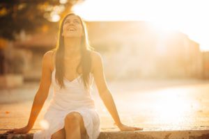 Image of a woman in a white dress smiling in the sun. We use EMDR therapy in Orlando and Winter Park to help with trauma, depression, anxiety, & more. Continue reading this blog to learn more about eye movement desensitization and reprocession. Our EMDR therapist can tell you if it is the right technique for you. Call today!